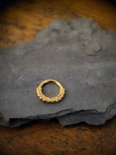 Unser Wreath Clicker ist aus hochwertigem Edelstahl hergestellt und ist ideal für dein Septum Piercing geeignet. Getoppt wird es durch das super schicke und einzigartige Design mit wunderschönen Edelstahldetails in Lorbeerkranz-Optik.